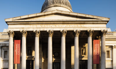 Front facade of a classical building with columns and a domed roof