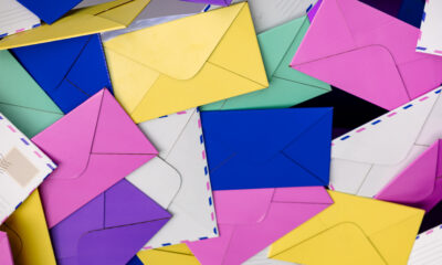 Pile of colorful envelopes in blue, pink, yellow and green