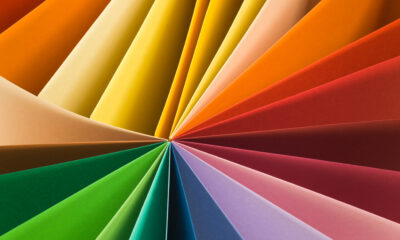 Fanned arrangement of colorful paper sheets radiating from a central point