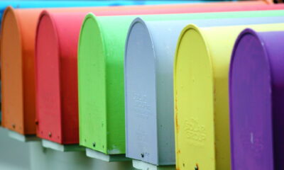 Row of colorful mailboxes in a rainbow of colors